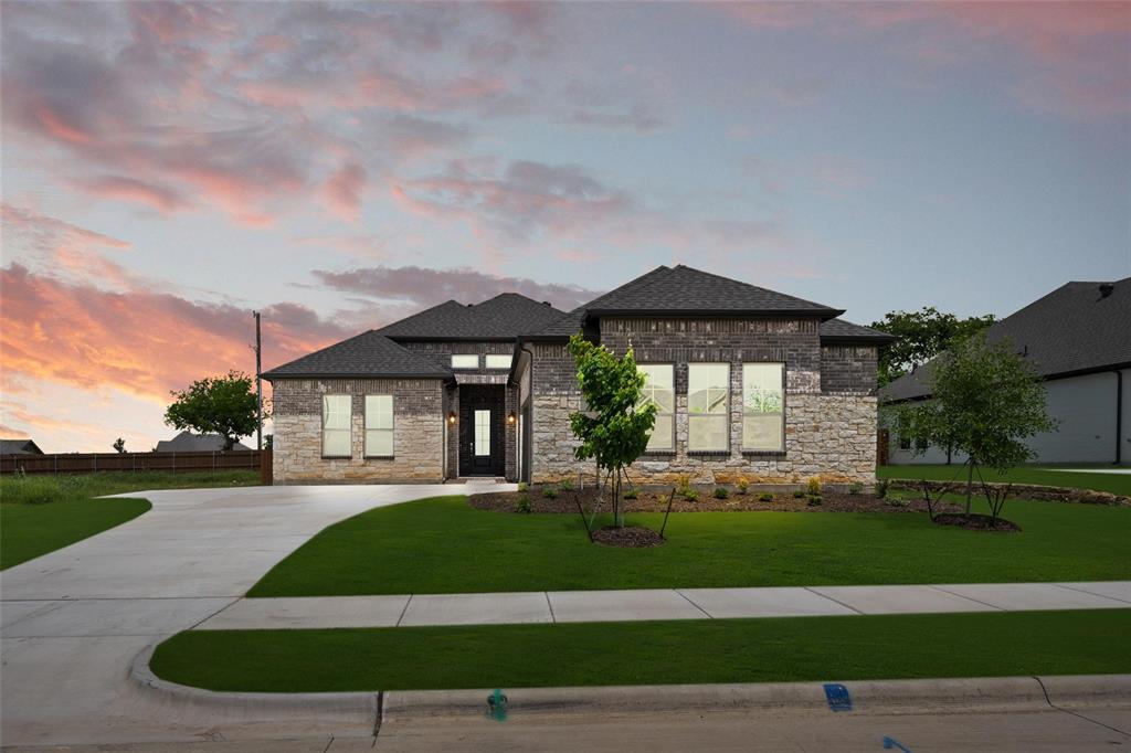 a front view of a house with a yard