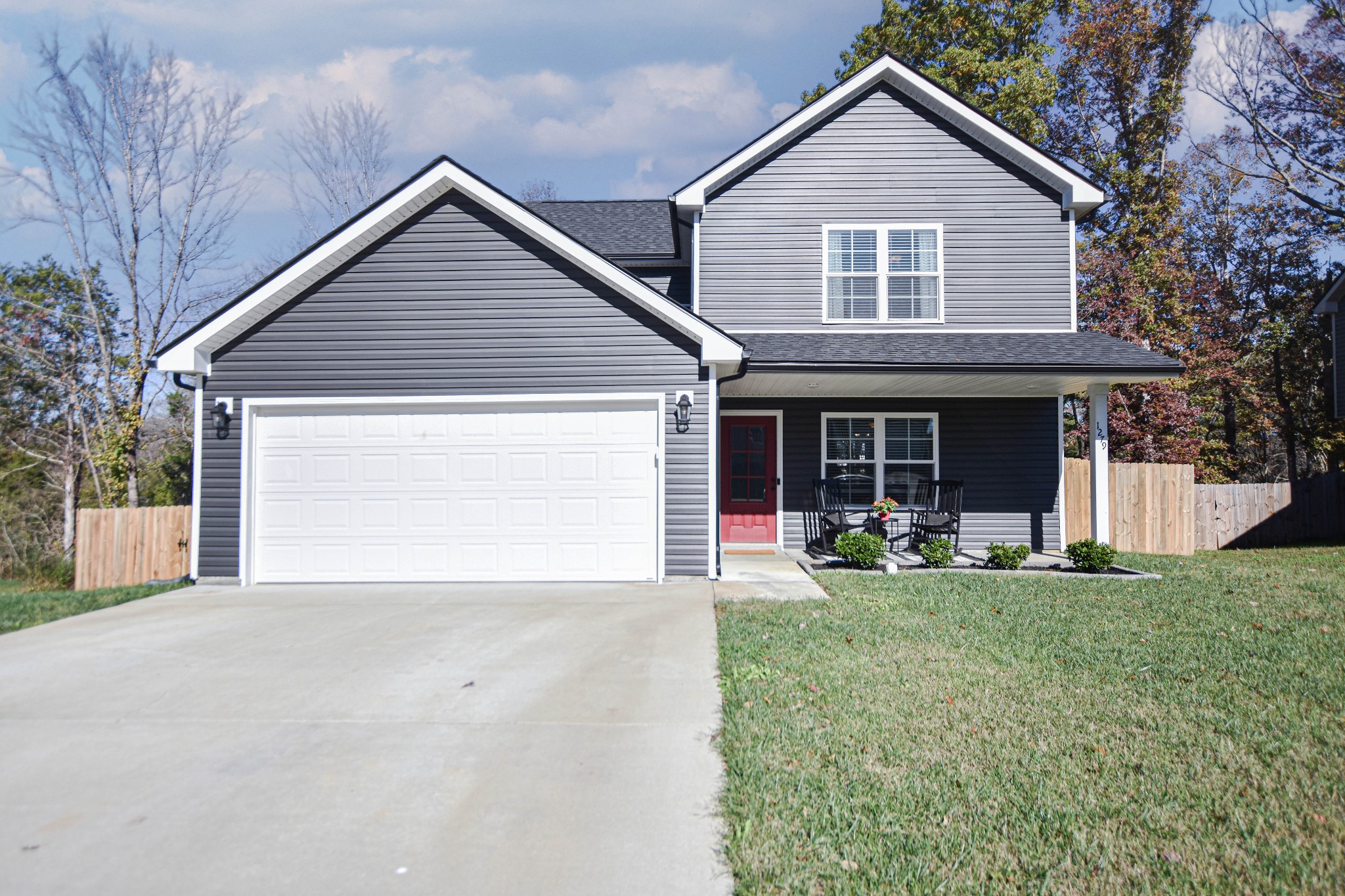 a front view of a house with a yard and porch