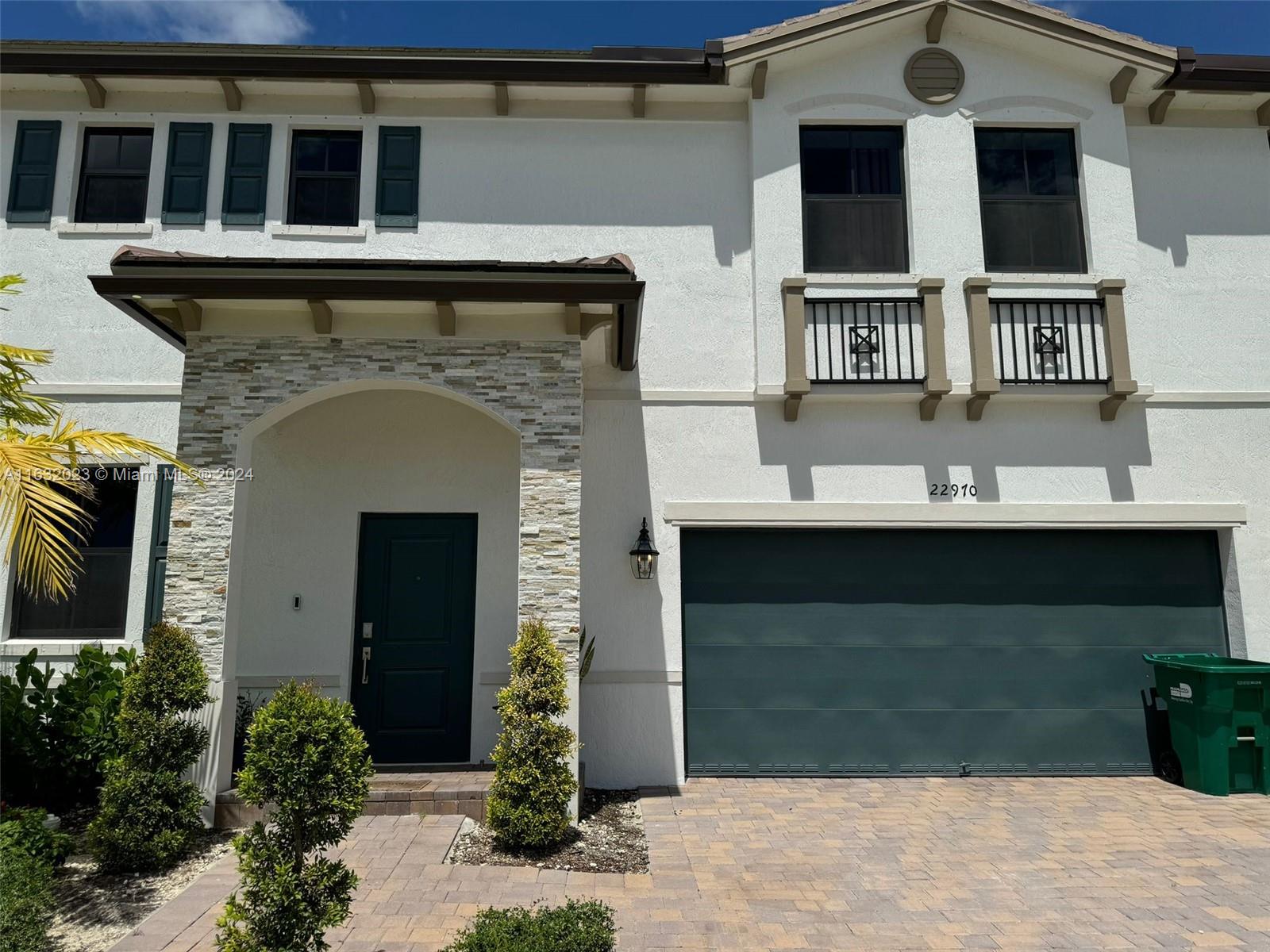 a front view of a house with a garage