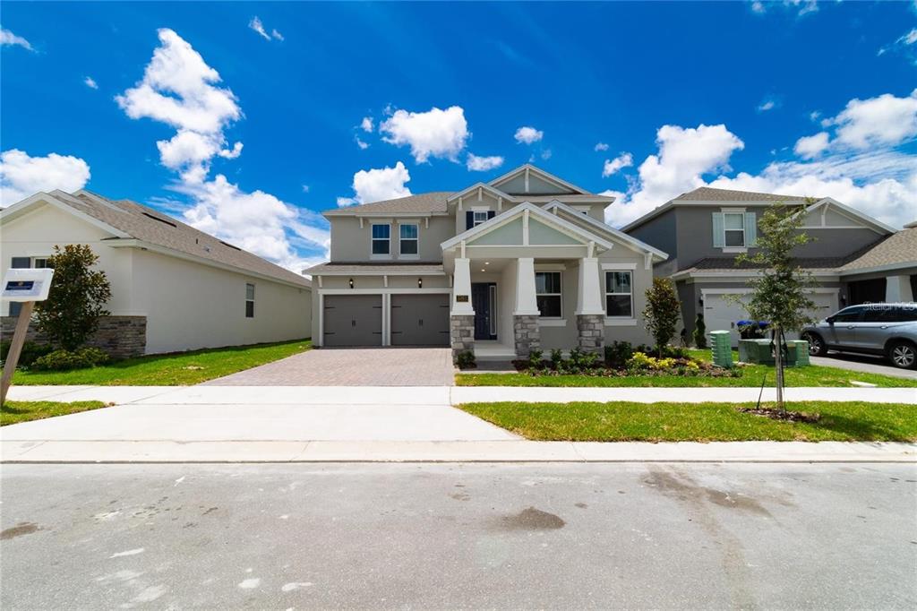 a front view of a house with a yard and a garage