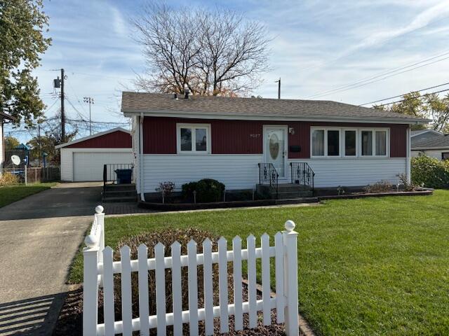 a front view of house with yard and garage