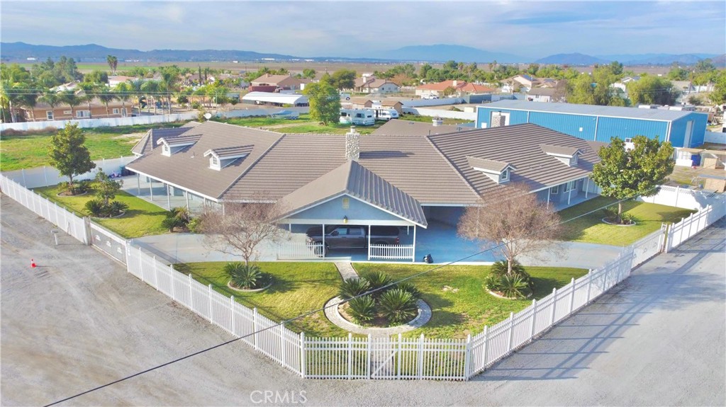 an aerial view of a house with swimming pool and ocean view