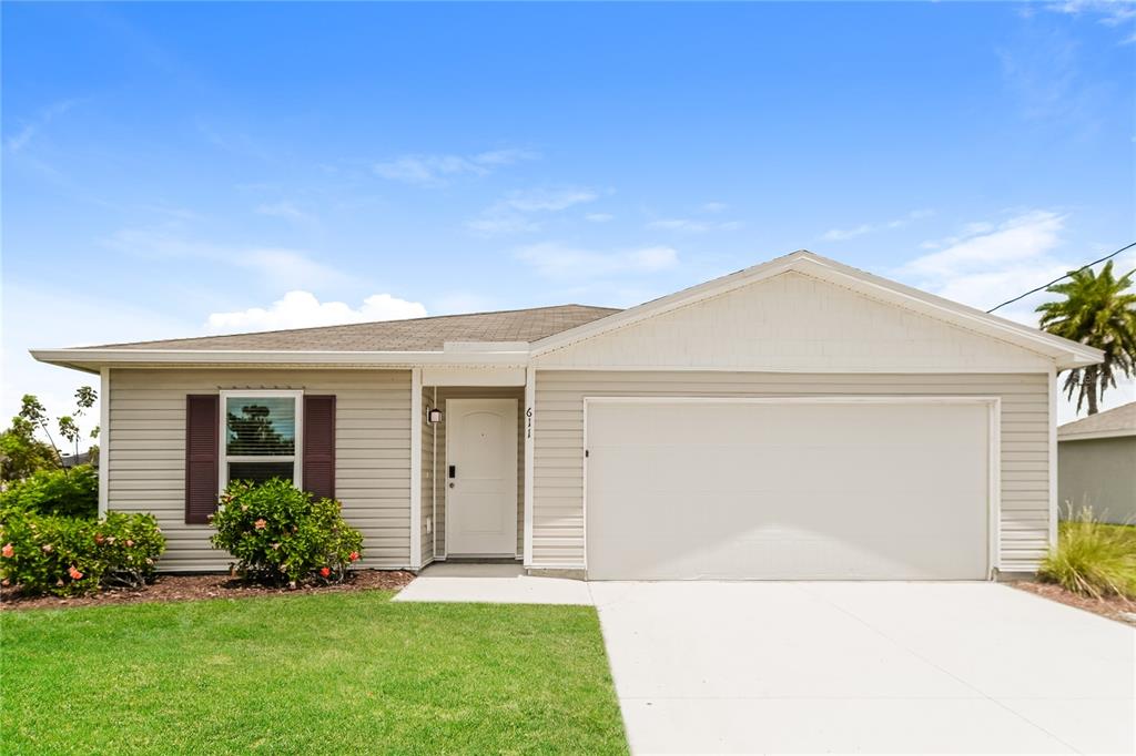 a front view of a house with a yard and garage