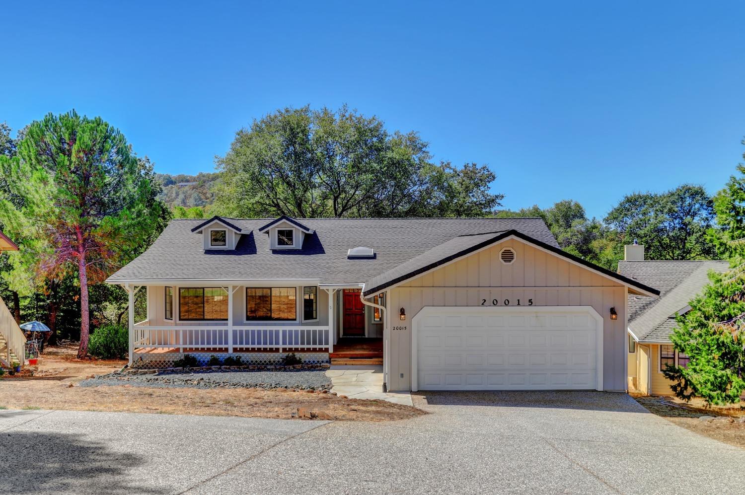 a view of house with outdoor space and a car parked in front of it