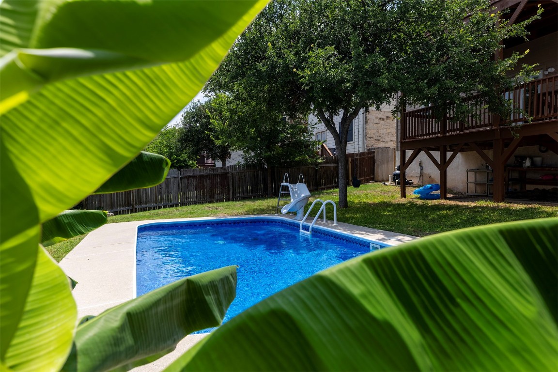 a view of a backyard with swimming pool