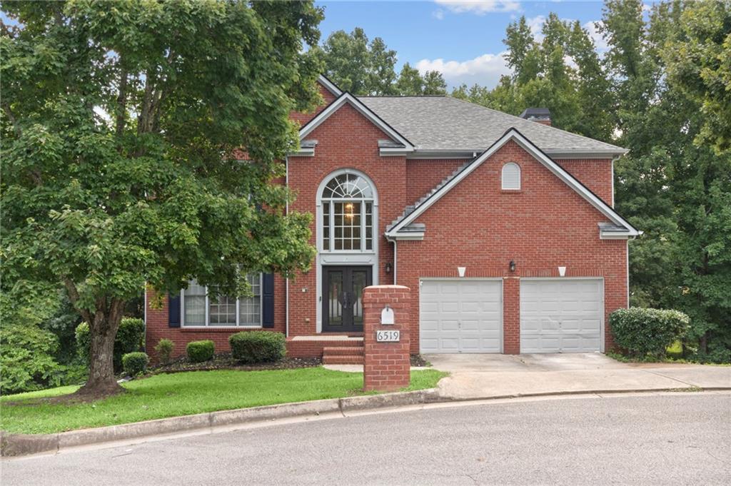 a front view of a house with a yard and garage