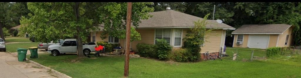 a view of an house with backyard space and garden