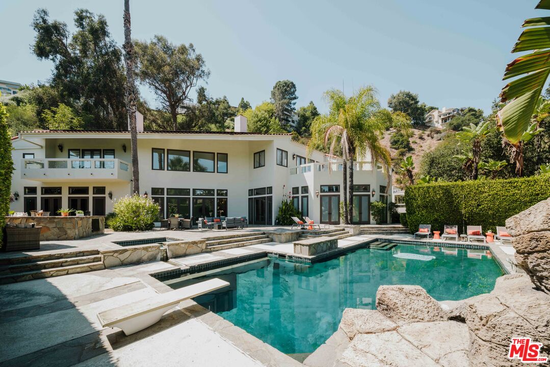 a view of a house with swimming pool and porch