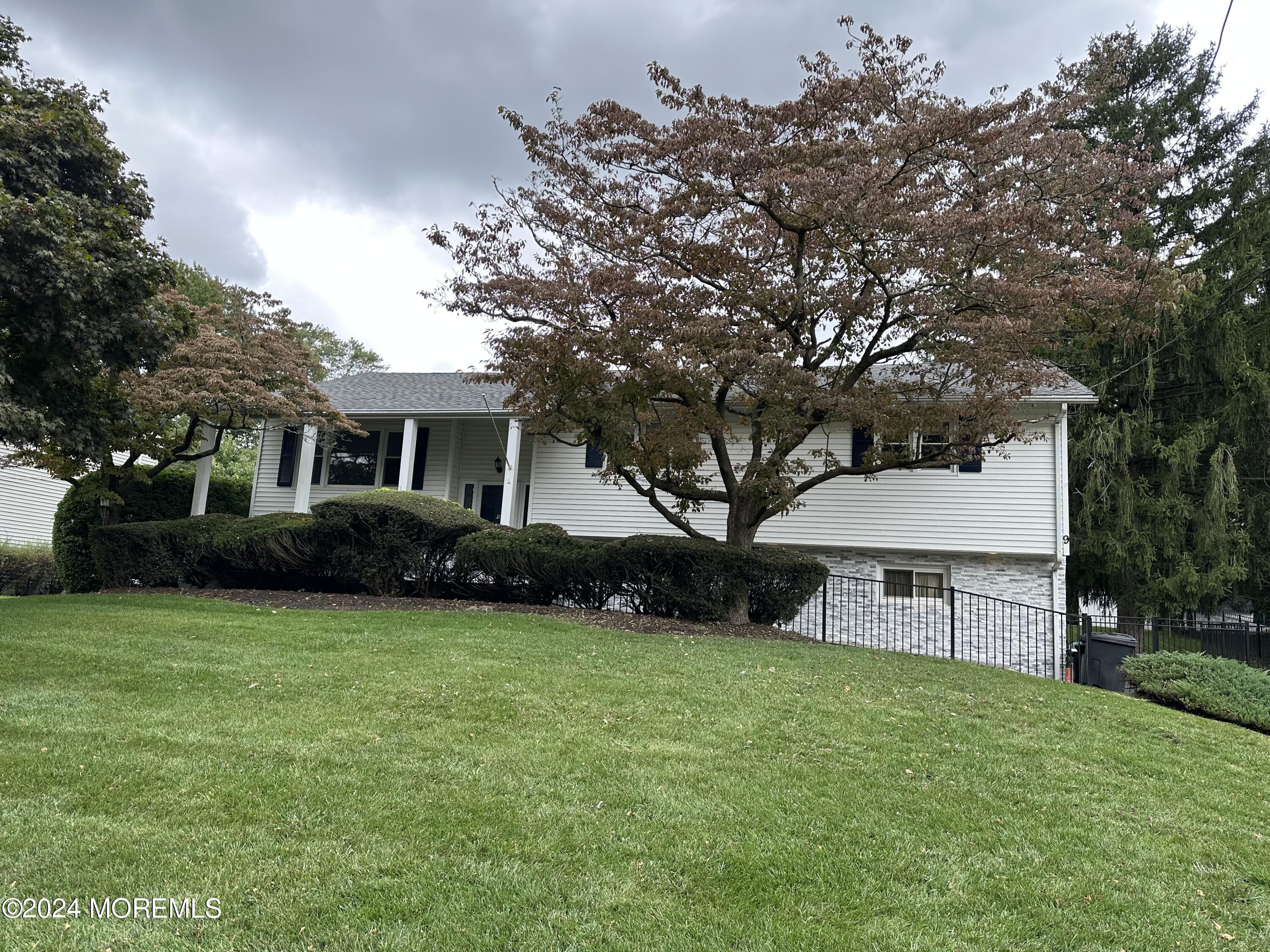 a view of house with outdoor space and garden