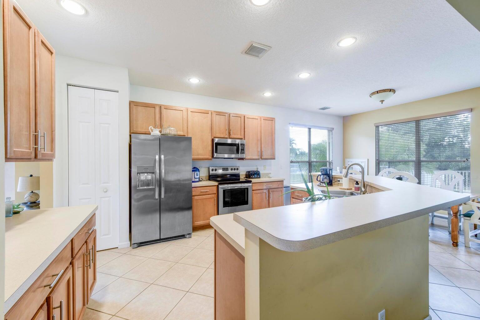 a kitchen with sink a stove and refrigerator