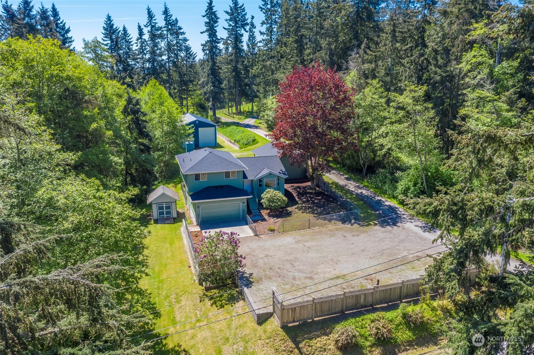 an aerial view of a house with a yard basket ball court and outdoor seating