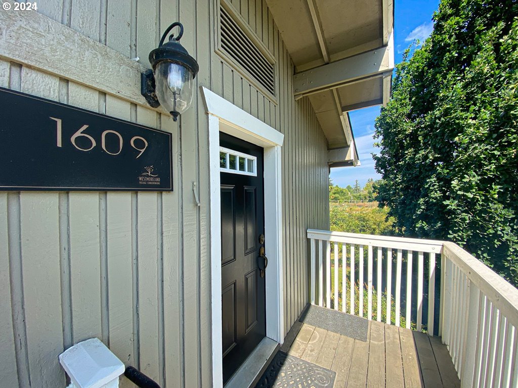 a view of a wooden door and a street sign