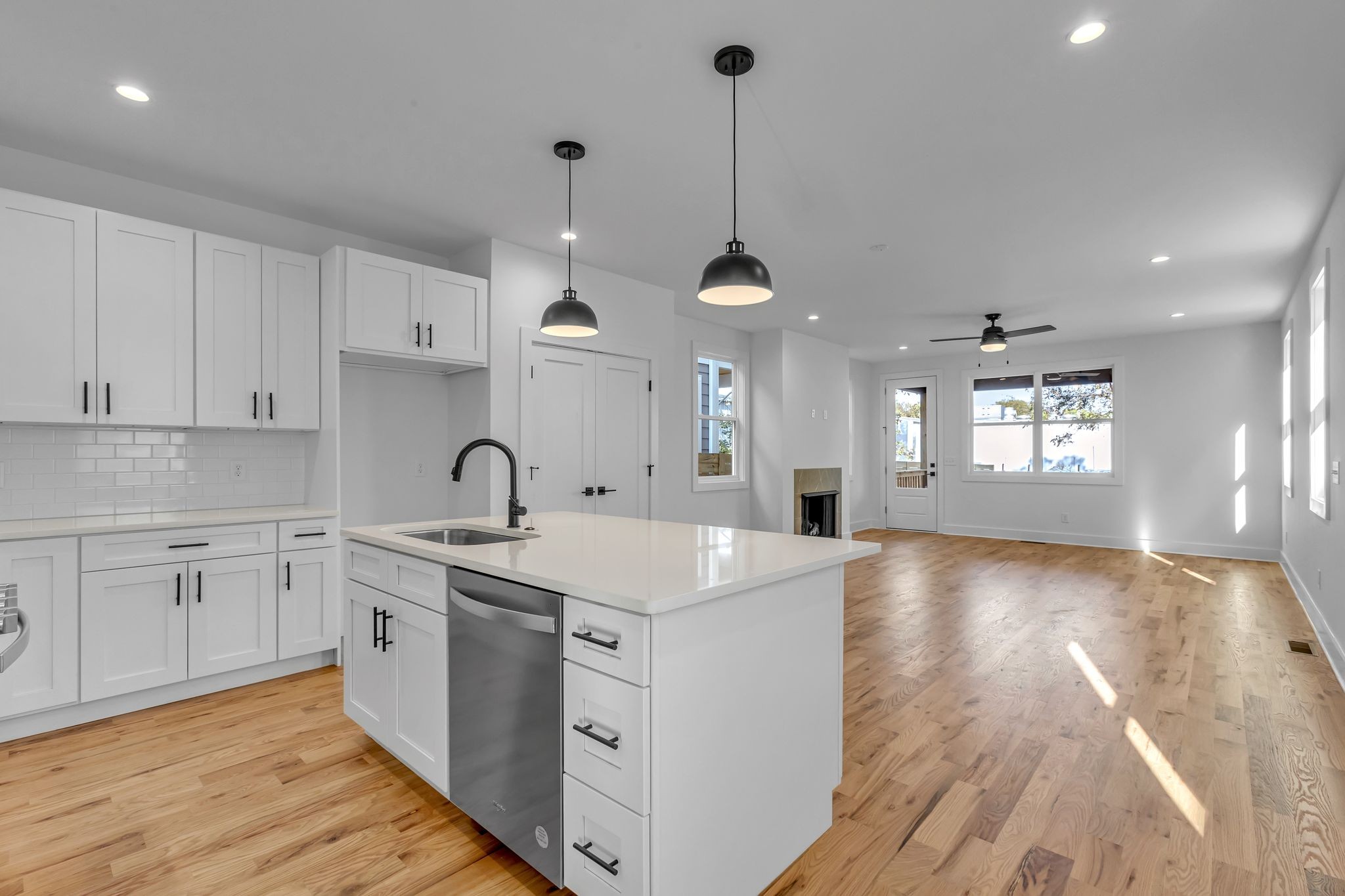 a view of a kitchen counter space a sink stainless steel appliances and cabinets