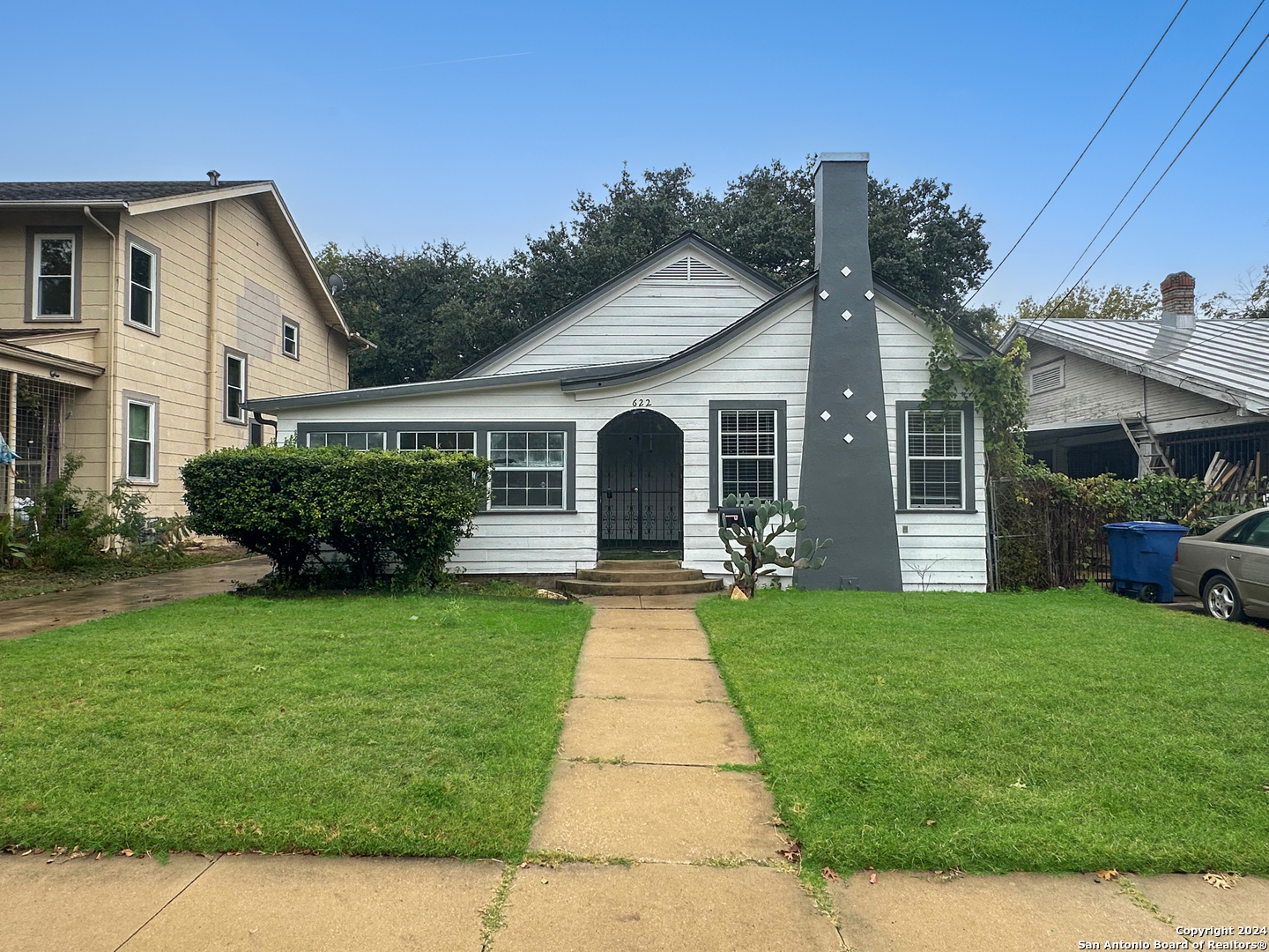 a front view of a house with a garden