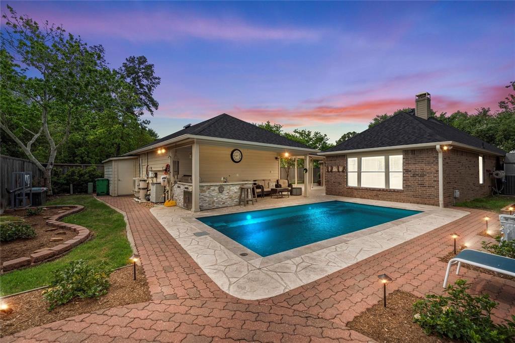 a view of a house with backyard patio and a garden