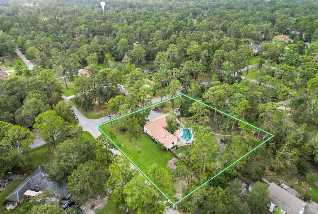 an aerial view of a house with a yard and lake view