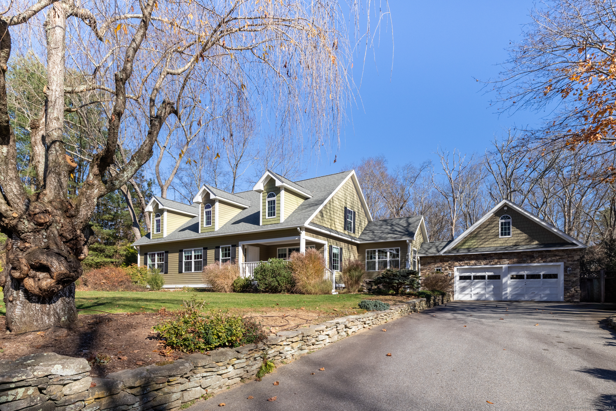 a front view of a house with a garden