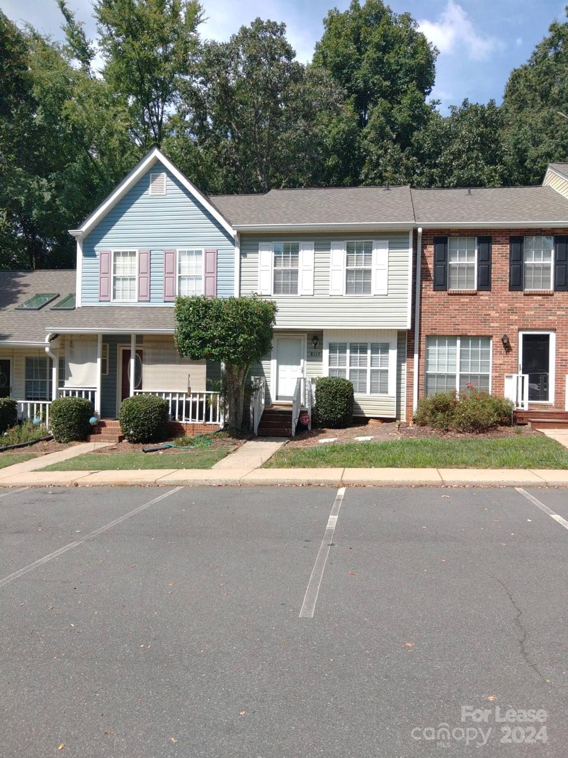 a front view of a residential apartment building with a yard