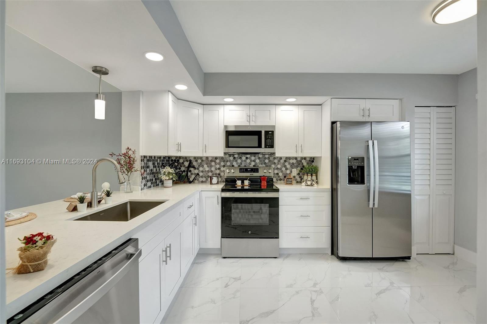 a kitchen with a sink cabinets and stainless steel appliances