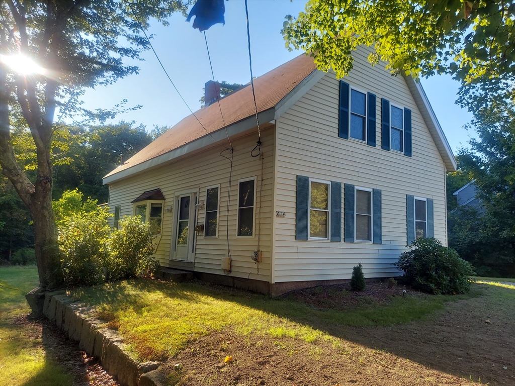 a view of a house with backyard and sitting area