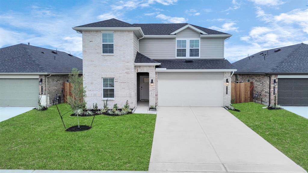 a front view of a house with a yard and garage