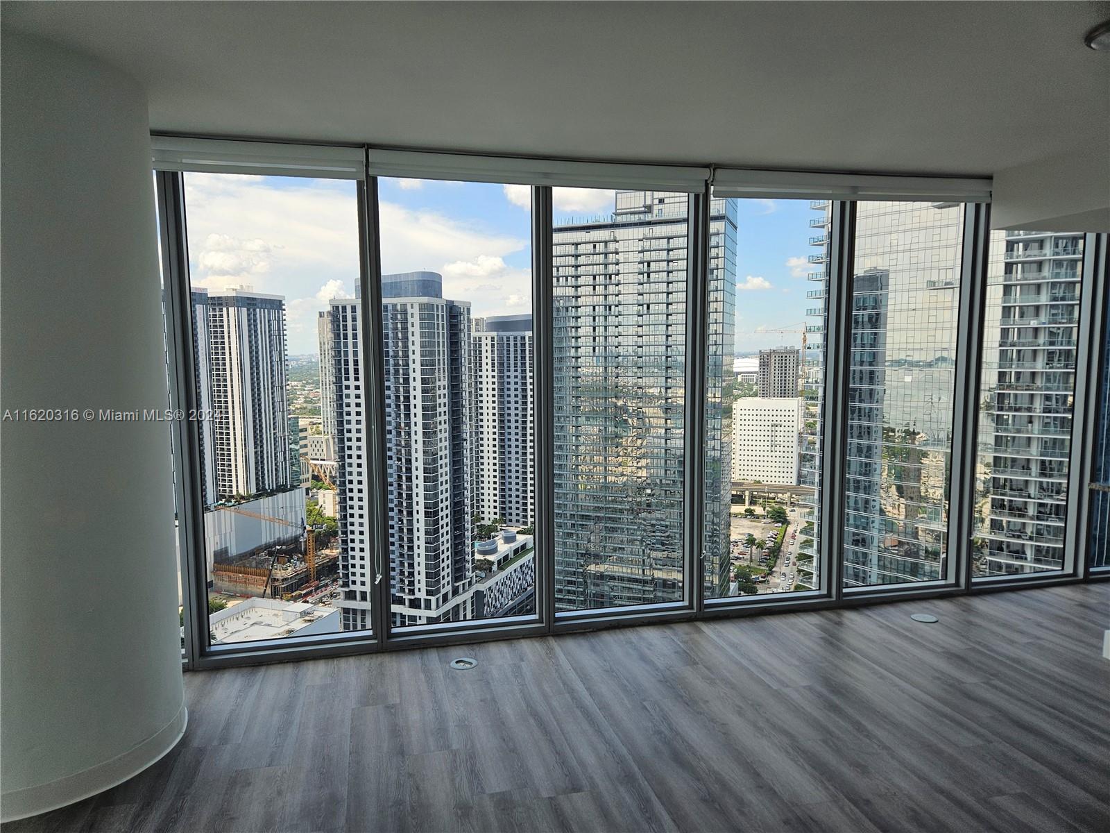 a view of a large window with wooden floor