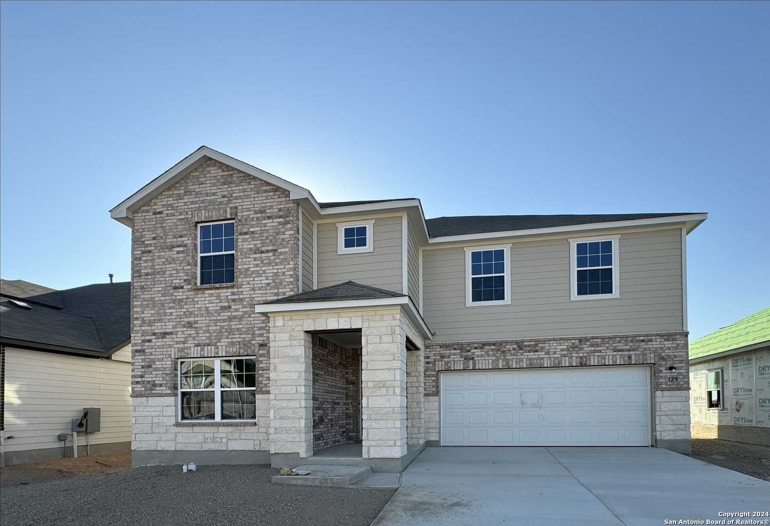 a front view of a house with a garage