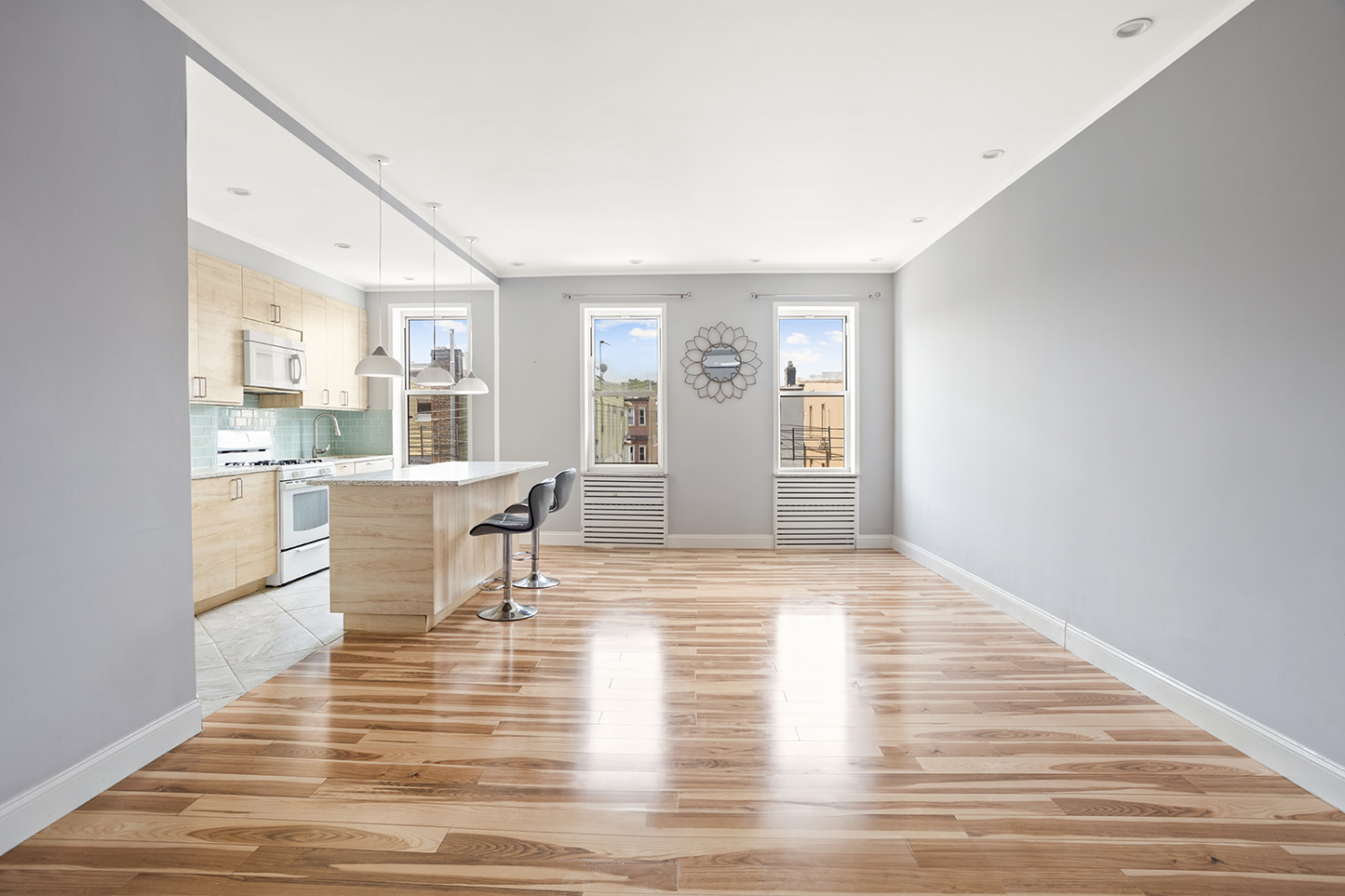 a living room with furniture and a wooden floor