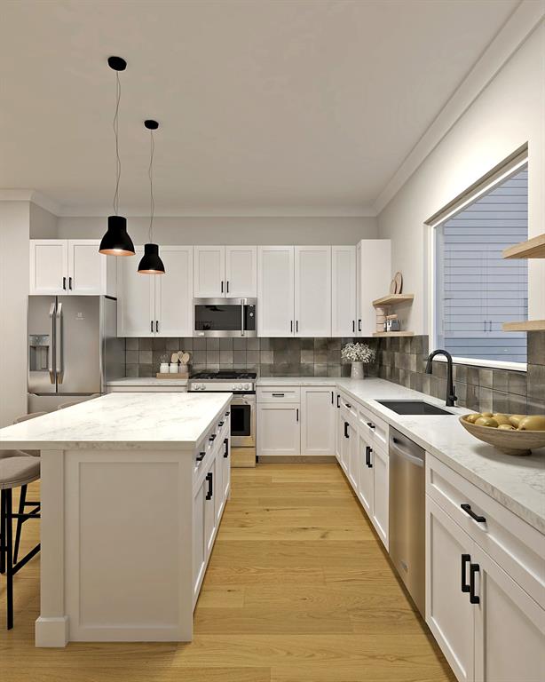 a white kitchen with stainless steel appliances granite countertop a stove a sink dishwasher and white cabinets with wooden floor