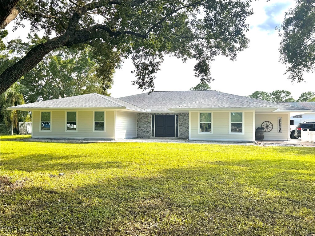 a front view of house with outdoor space and swimming pool