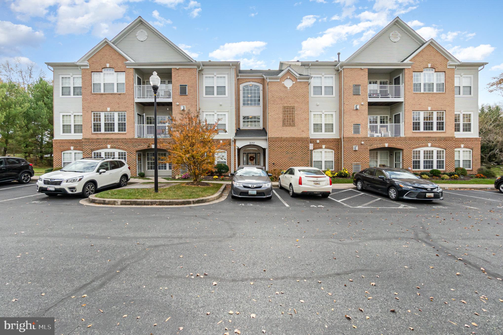 a view of a cars park in front of a building