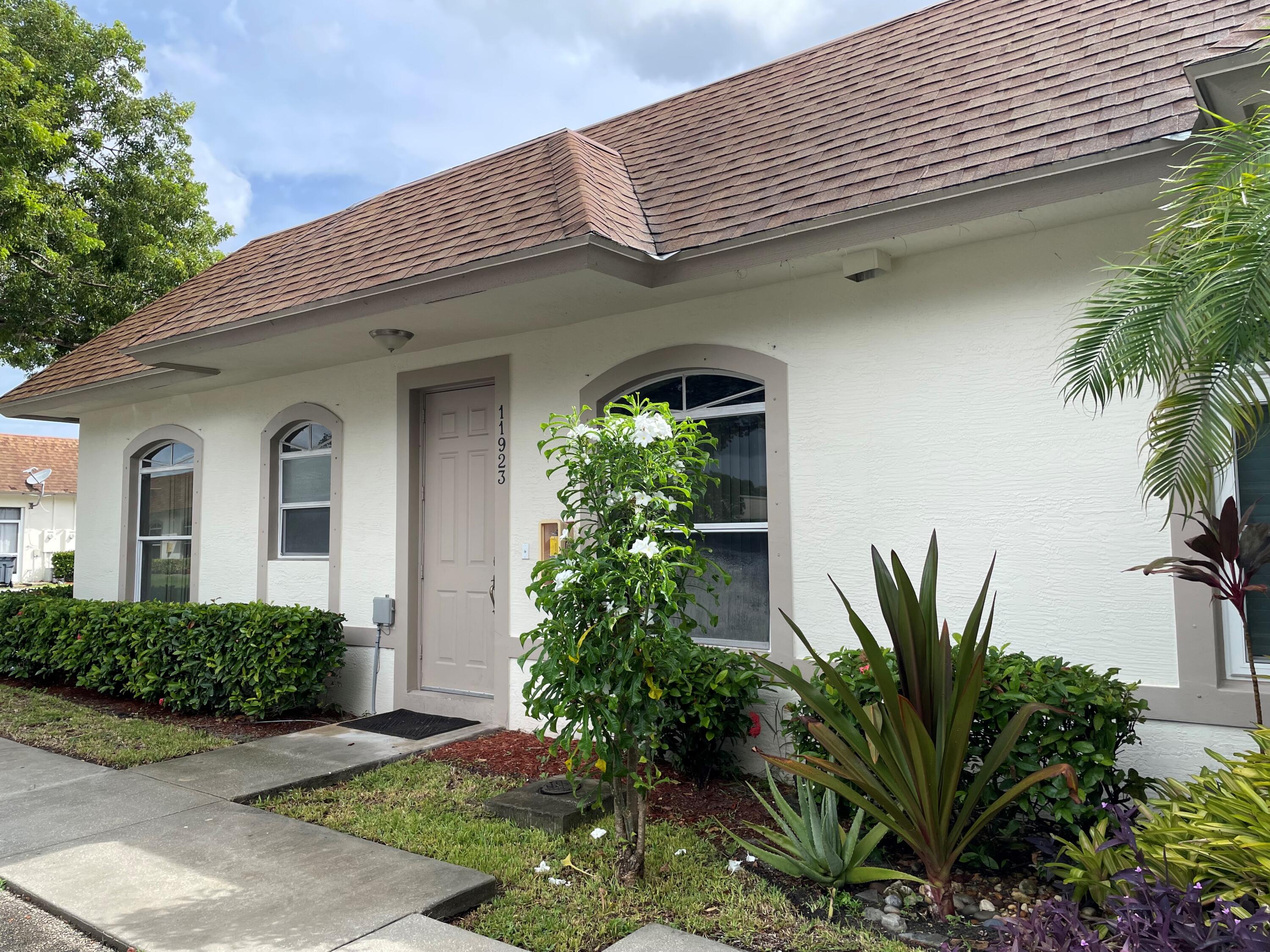 a front view of a house with a garden