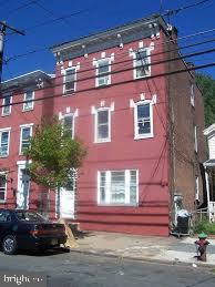 a front view of a building with a yard