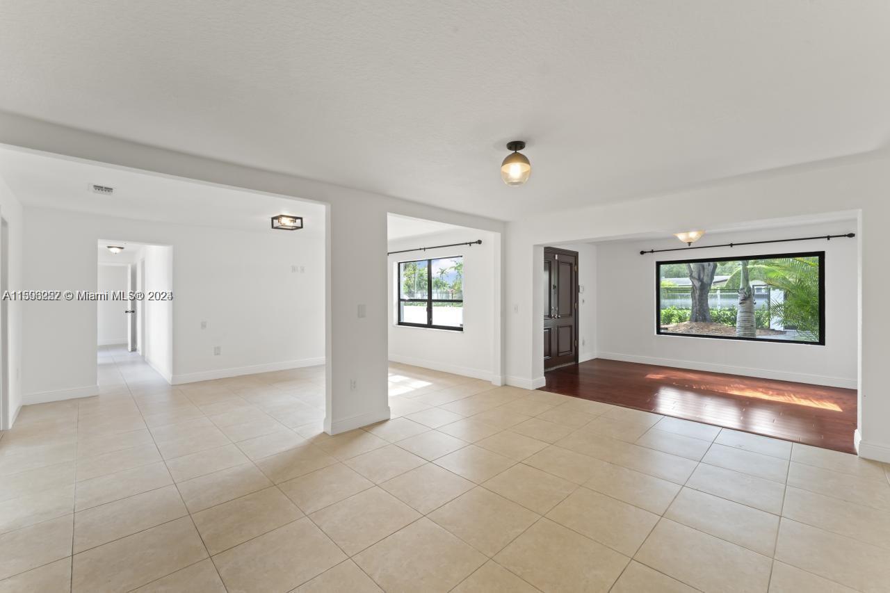 an empty room with windows and entrance