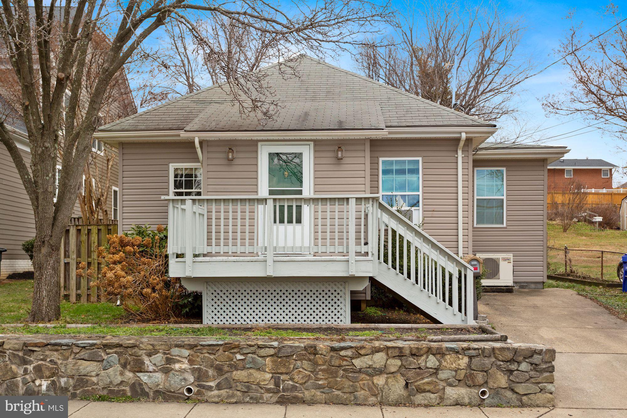 a view of a house with a window and wooden fence