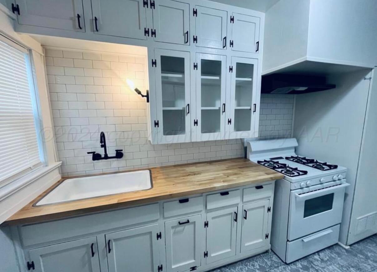 a kitchen with stainless steel appliances a stove and a microwave