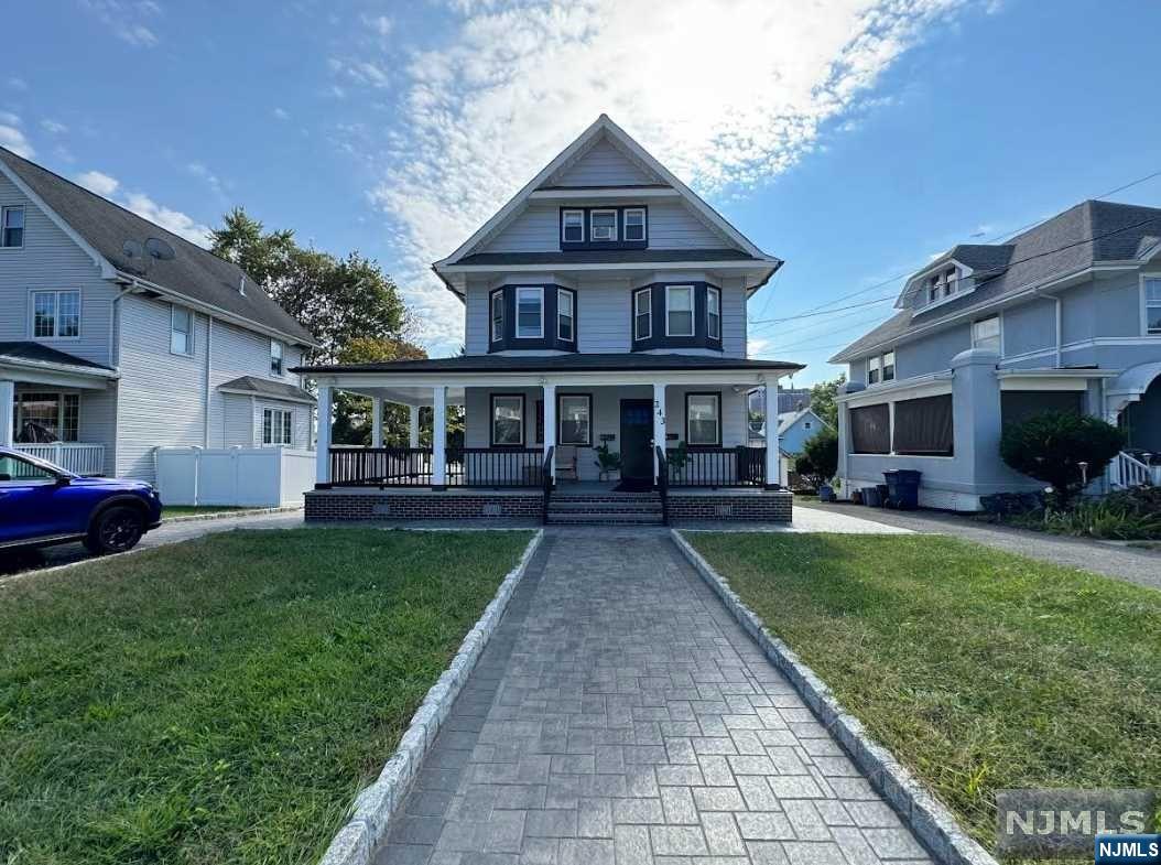 a front view of a house with a garden and patio