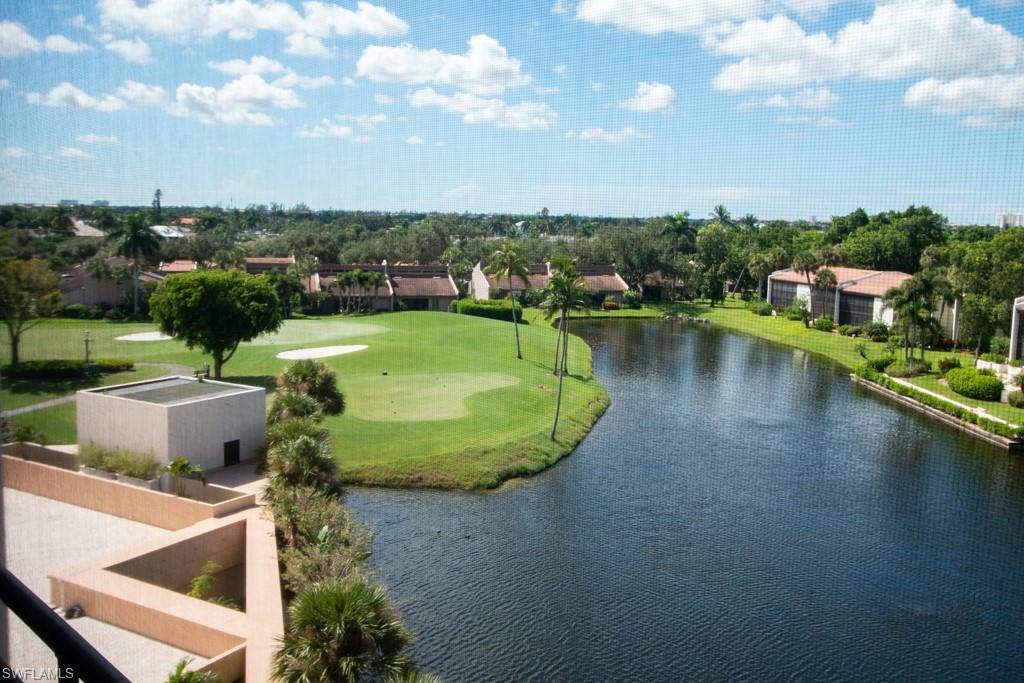 a view of a swimming pool with a patio and a yard