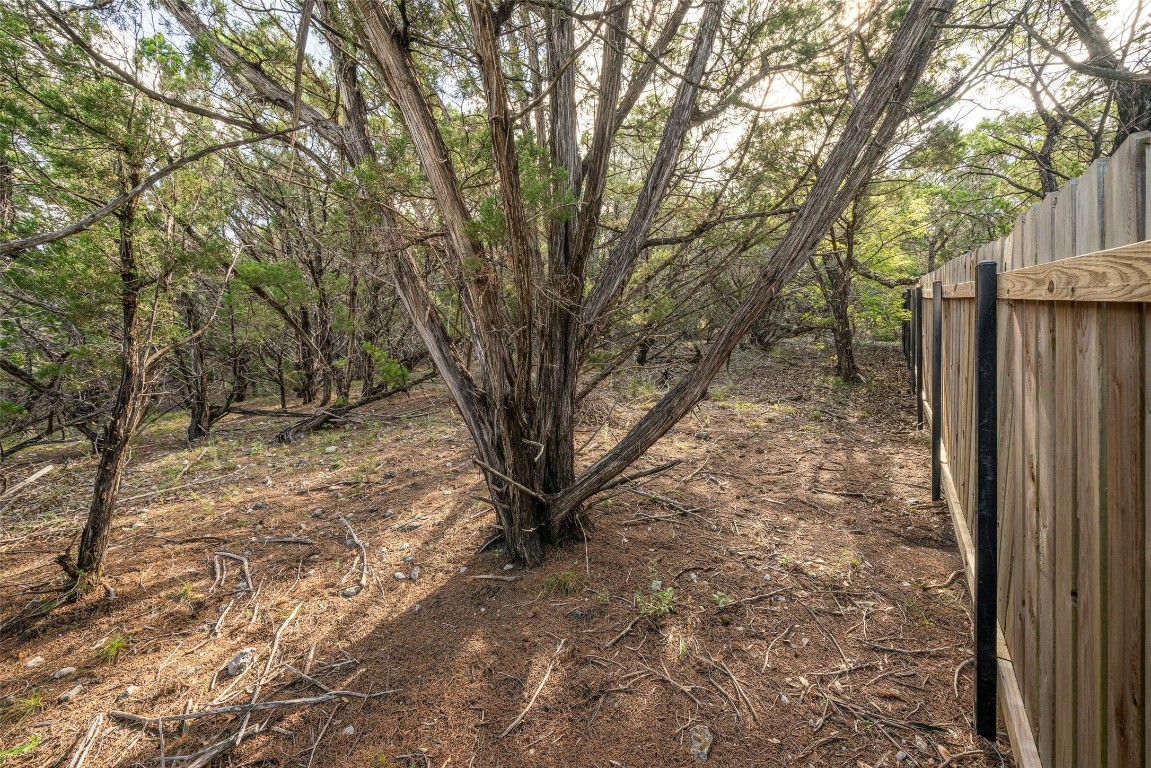 Welcome to 7900 Arapaho Trl. Partial fence-line near the back of the property.