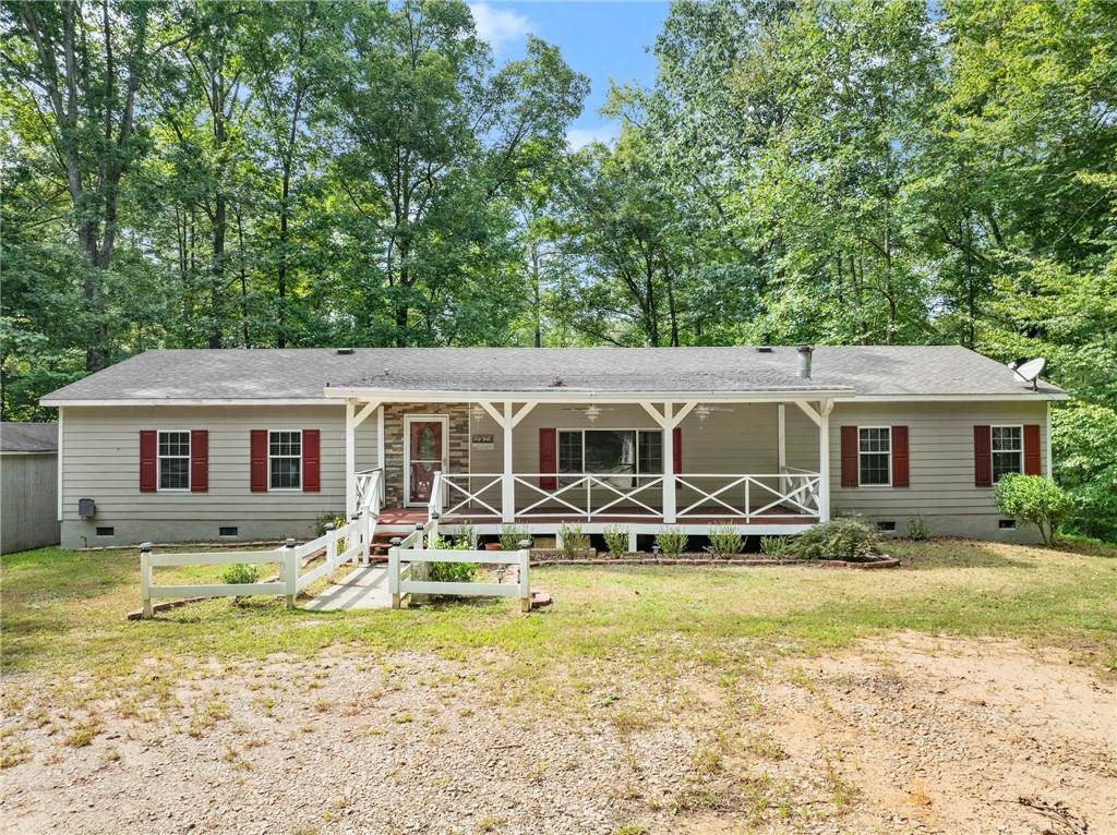 a front view of house with yard space and seating area