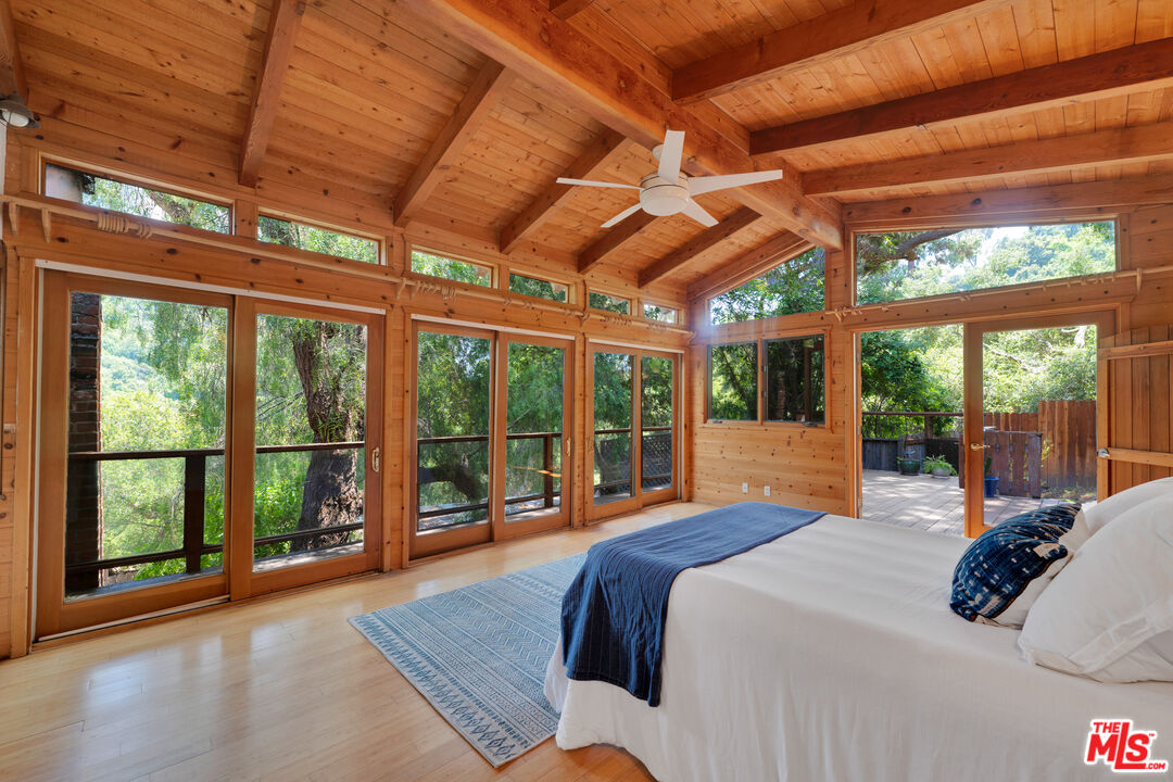 a bed sitting in a bedroom next to a large window