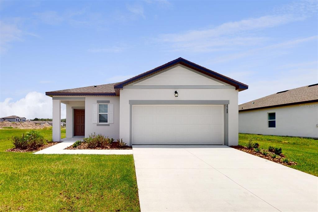 a front view of a house with a yard and garage