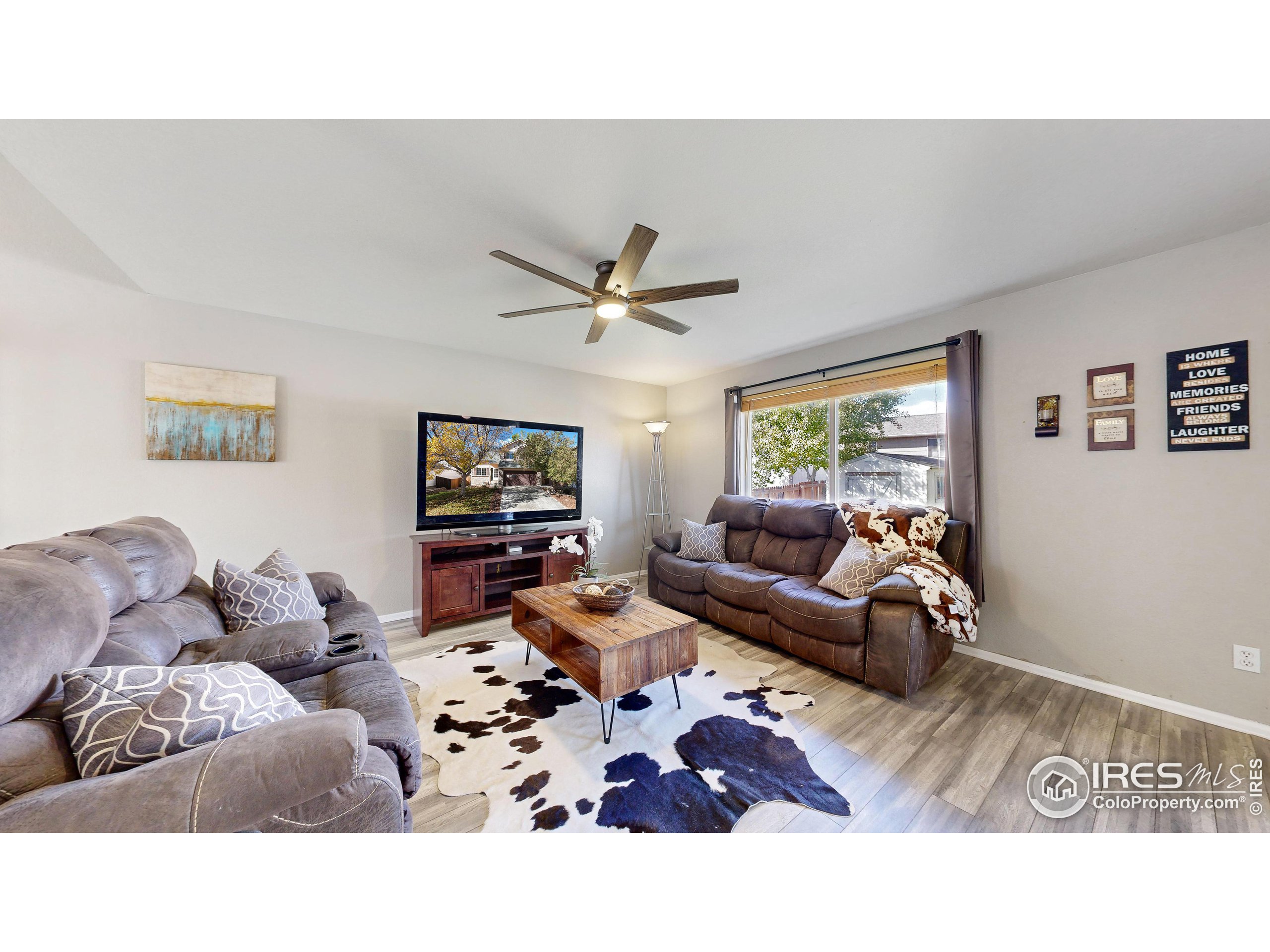 a living room with furniture and a ceiling fan