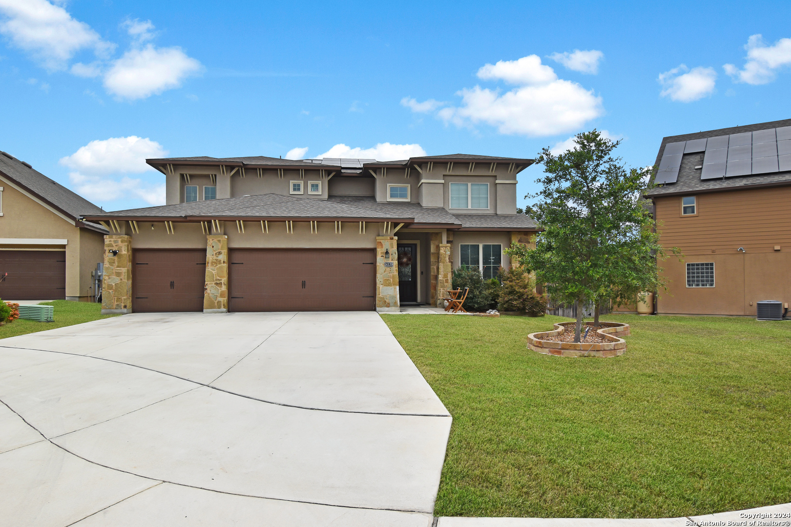 a front view of a house with a yard and garage