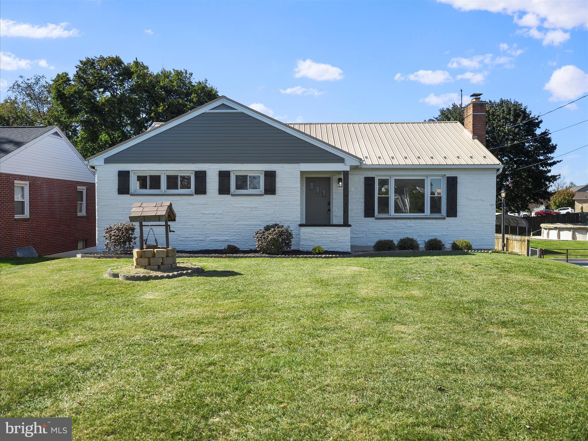 a front view of a house with a garden