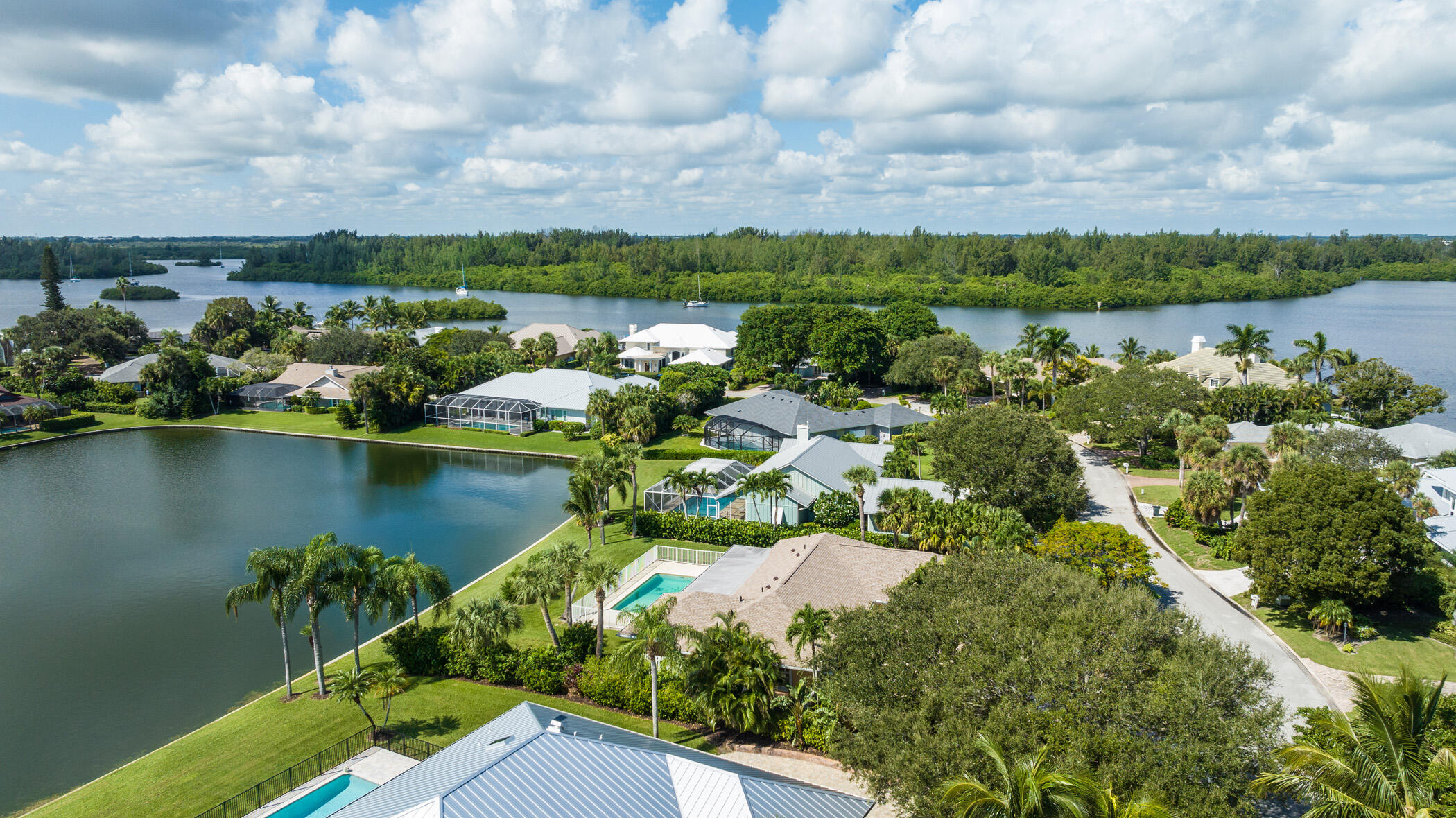 a view of a lake with houses in back