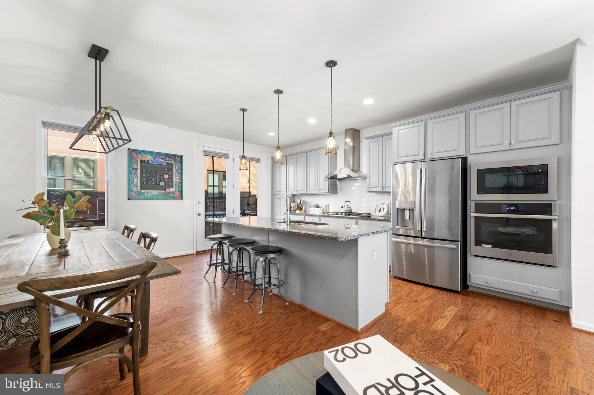 a open kitchen with stainless steel appliances granite countertop a stove refrigerator and a sink