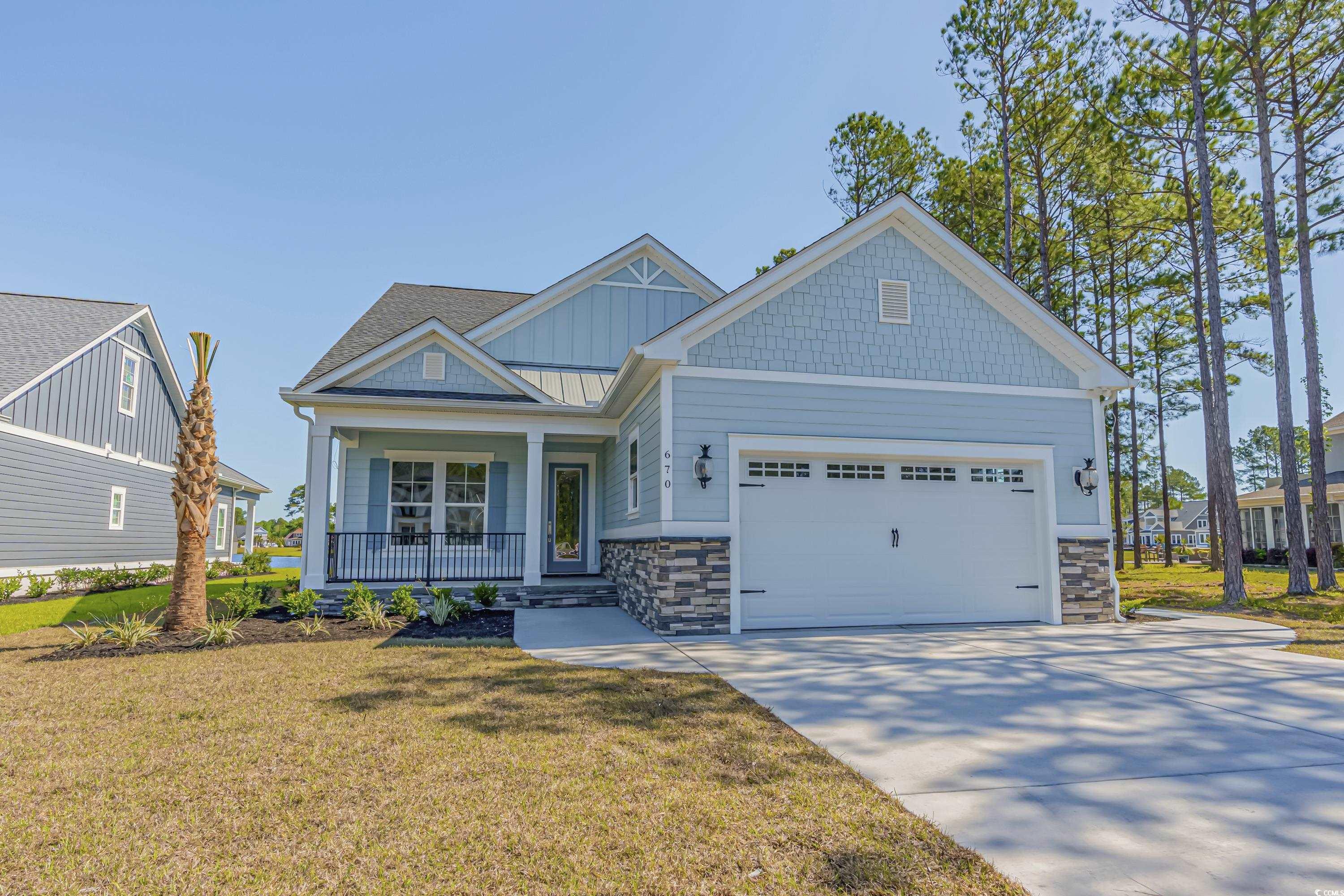 Craftsman-style home with a front lawn, a garage,