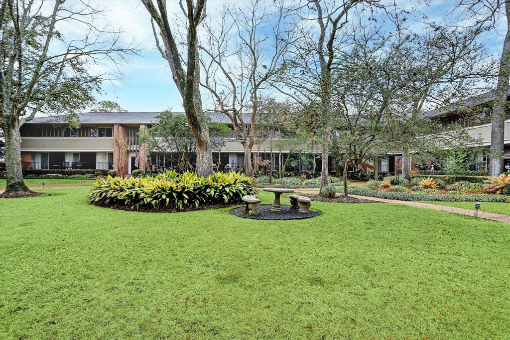 a view of a house with garden and sitting area