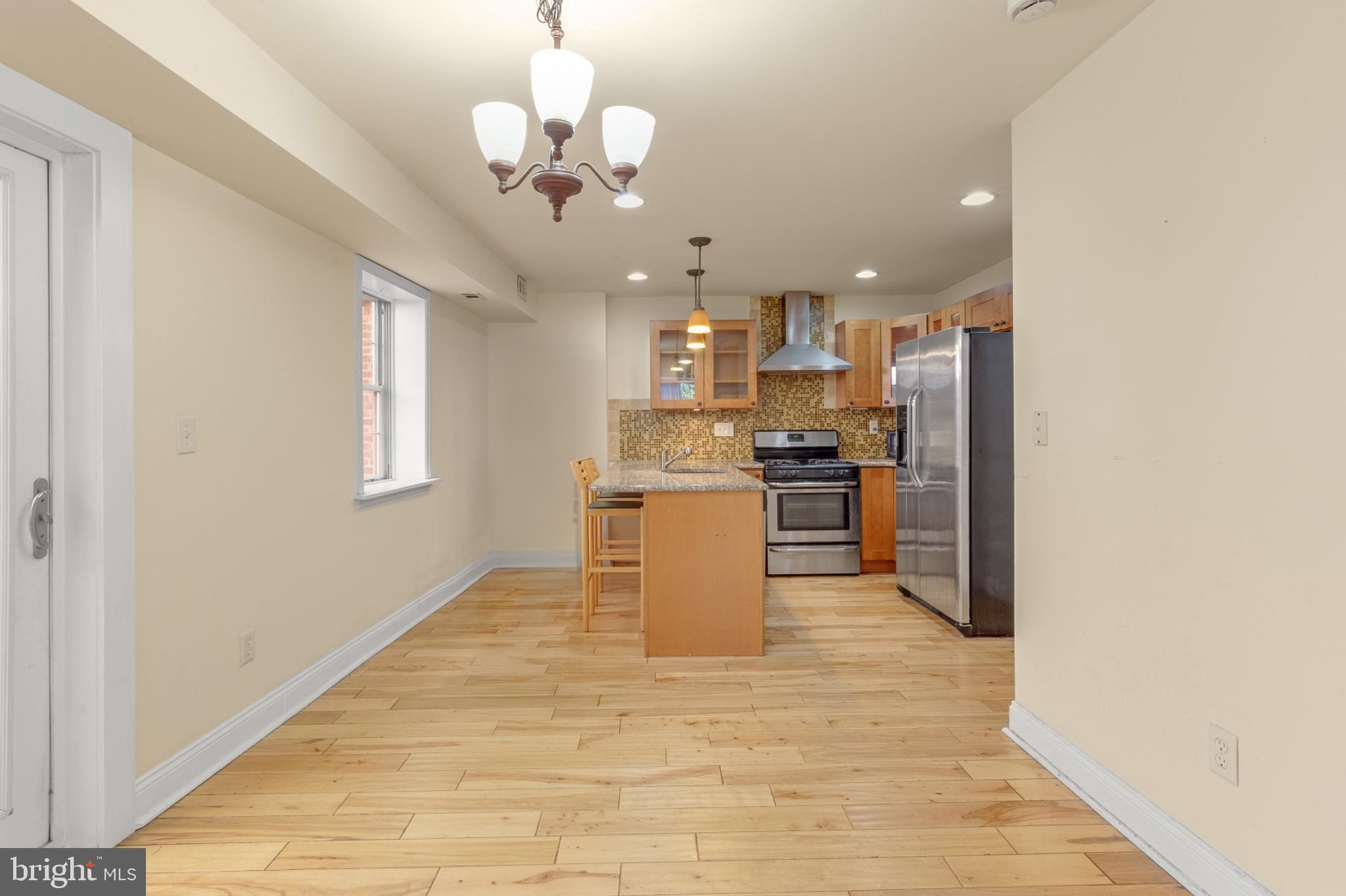 a view of a kitchen with a sink and cabinets